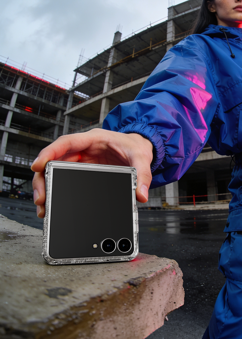 Samsung Galaxy Z Flip 8 folded closed in a clear ITSKINS case resting on concrete, cover screen and cameras visible